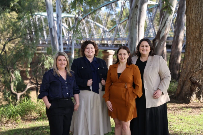 Four women posing in front of a bridge - Farrelly Hill Law supplied